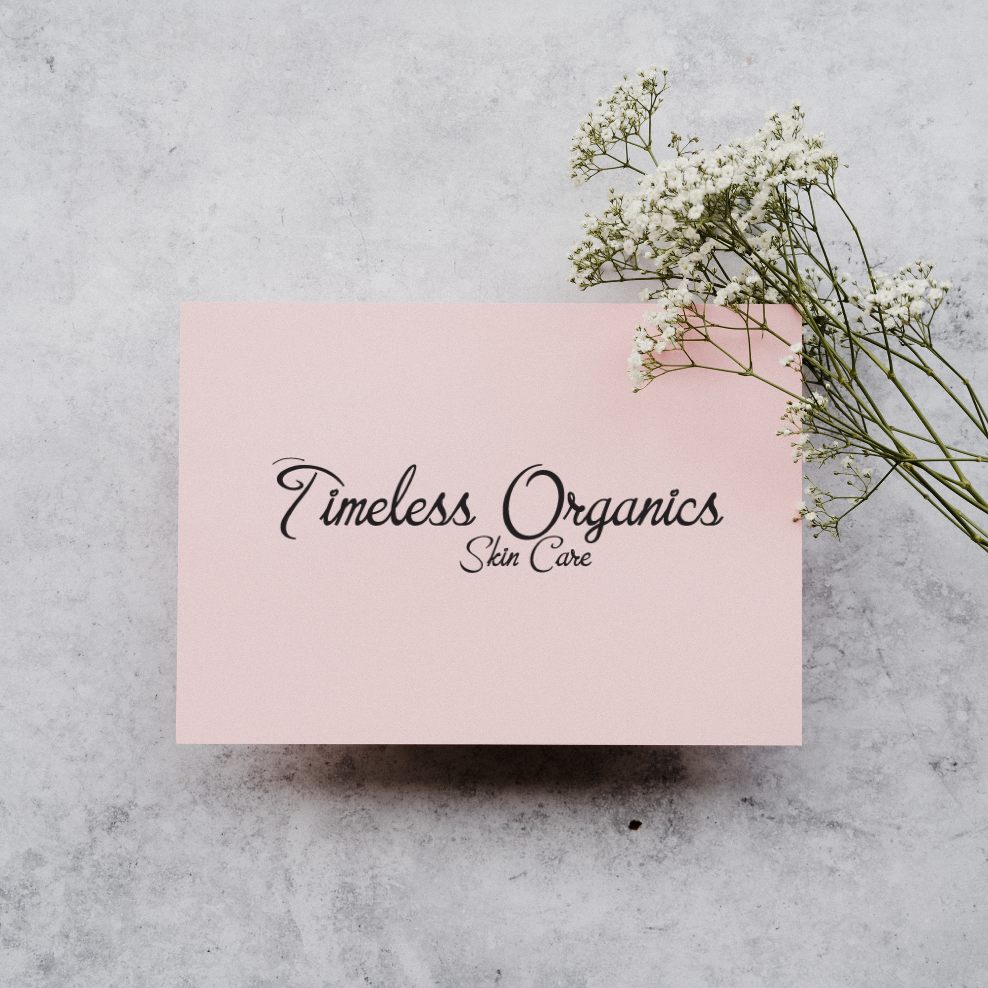 Timeless Gift Card with Timeless Organics logo and floral accent on a marble background
