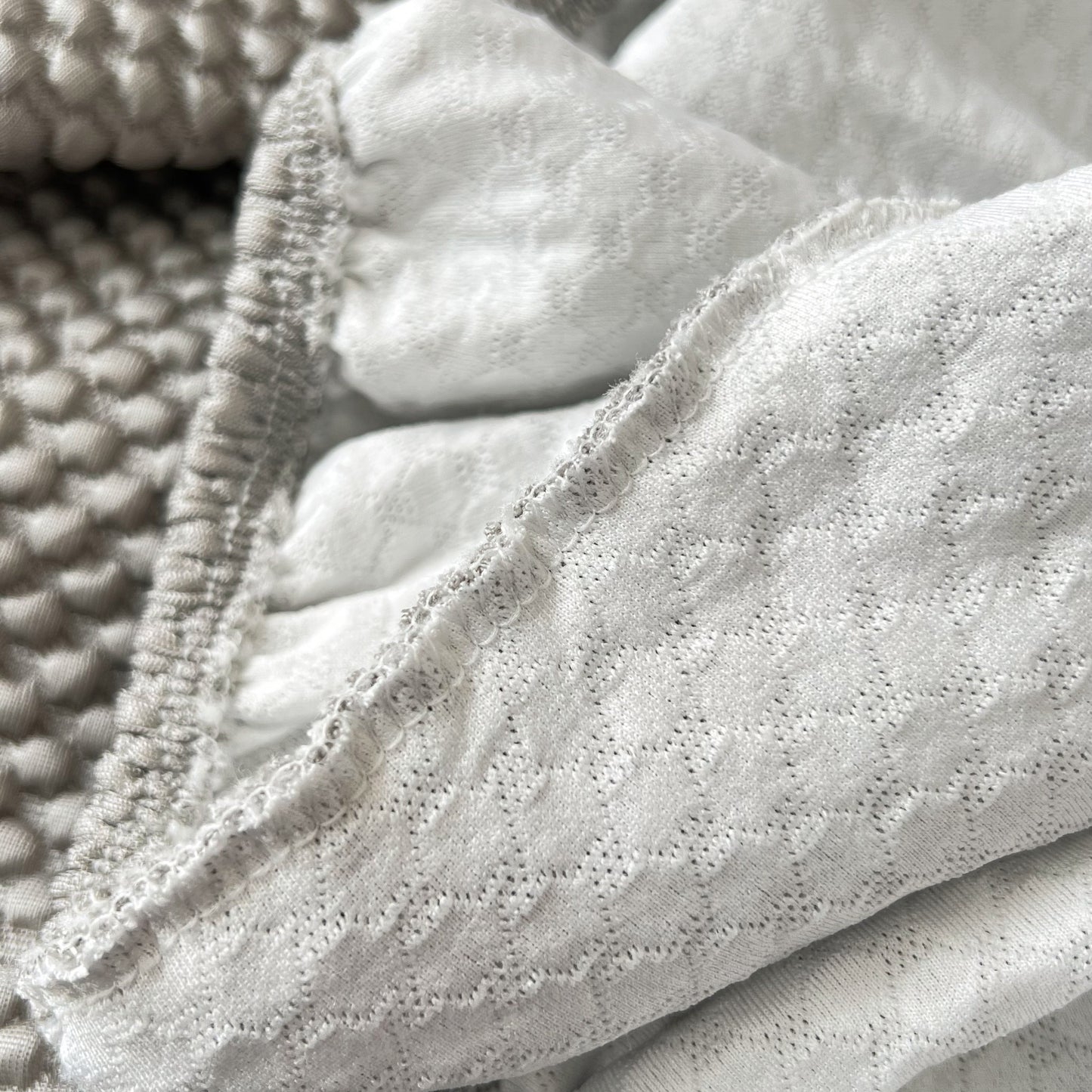 Close-up of Cooling Stretch Sofa Seat Cushion Covers, Slip Covers for Cushions, Universal Couch Cushion Protector showing fabric texture.