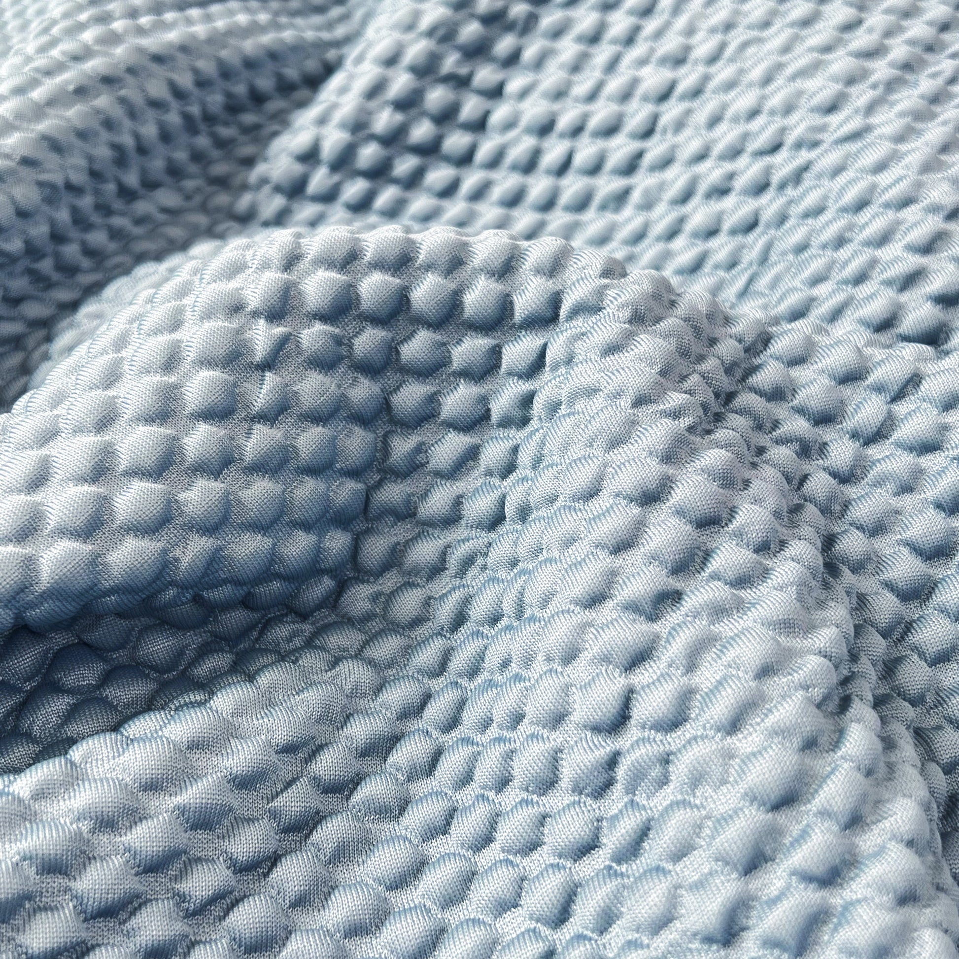 Close-up of textured fabric for Cooling Stretch Sofa Seat Cushion Covers, Slip Covers for Cushions, Universal Couch Cushion Protector.