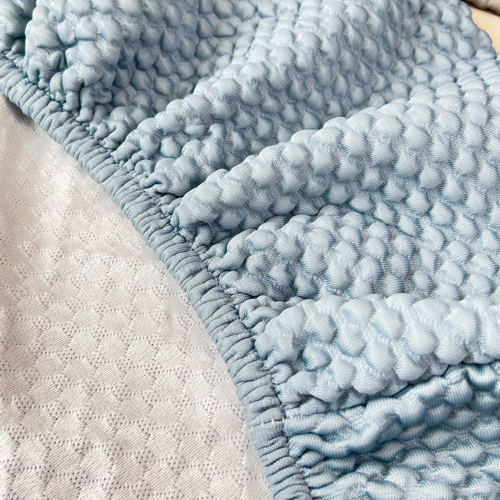 Close-up of Cooling Stretch Sofa Seat Cushion Covers, Slip Covers for Cushions, Universal Couch Cushion Protector in textured fabric