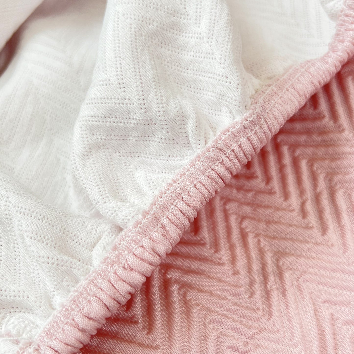 Close-up of Cooling Stretchy Replacement Couch Cushion Covers for Sectional, Individual Couch Seat Cushion Covers in pink and white fabric.