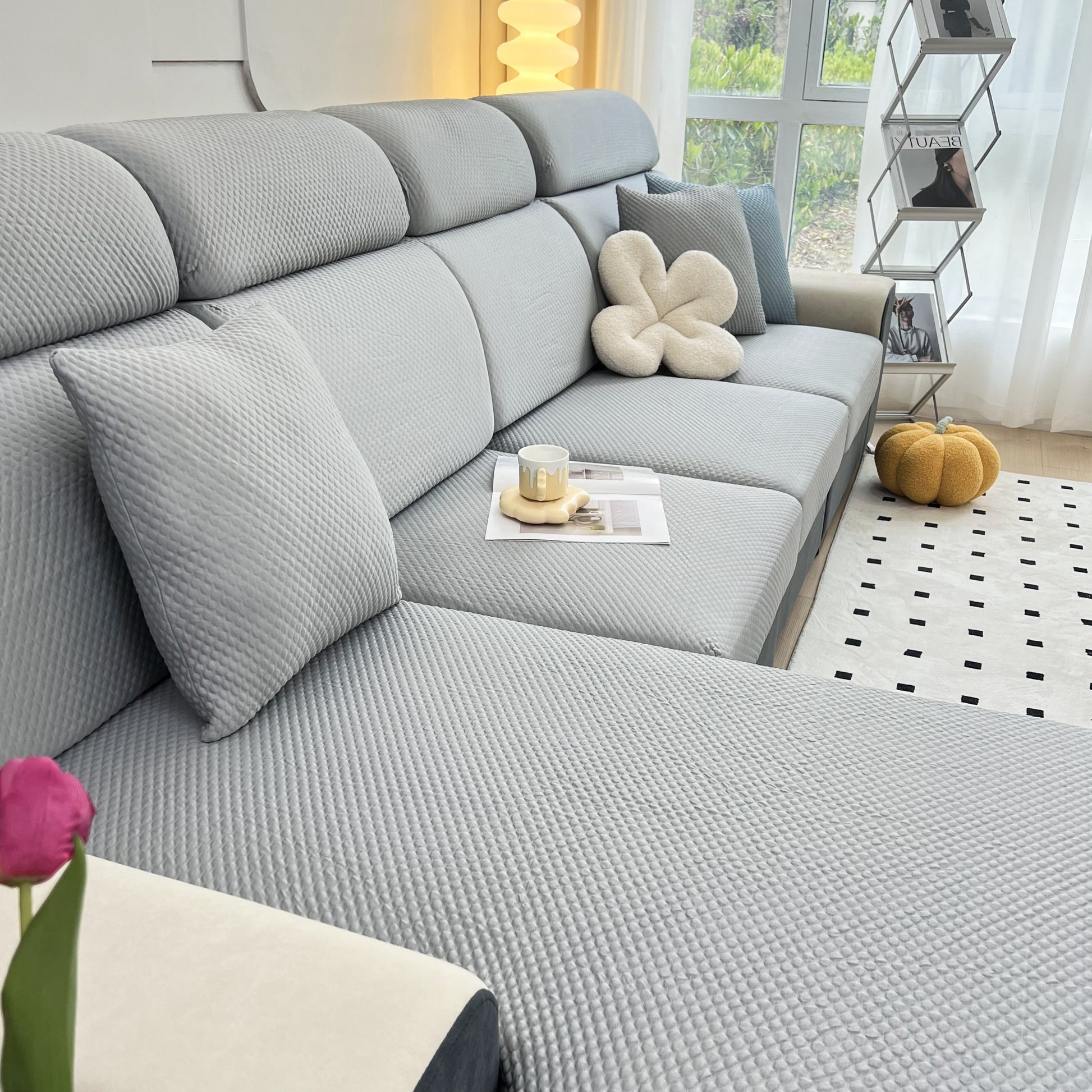 Cooling Stretch Sofa Seat Cushion Covers on a modern grey sofa in a bright living room, showcasing slip covers for cushions.