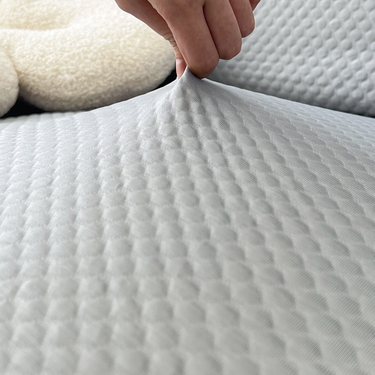 Close-up of Cooling Stretch Sofa Seat Cushion Covers showcasing the texture and snug fit on a couch cushion.