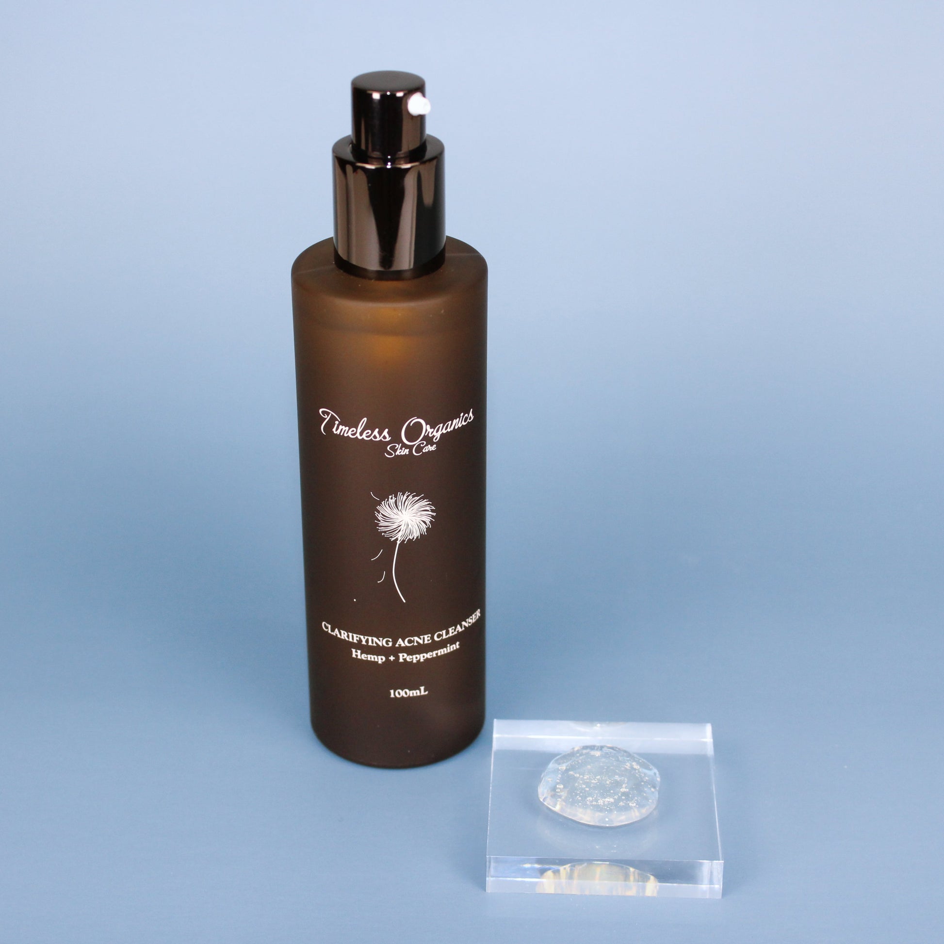 Clarifying Acne Cleanser bottle with brown label on blue background, focusing on soothing and natural skincare for clearer skin.