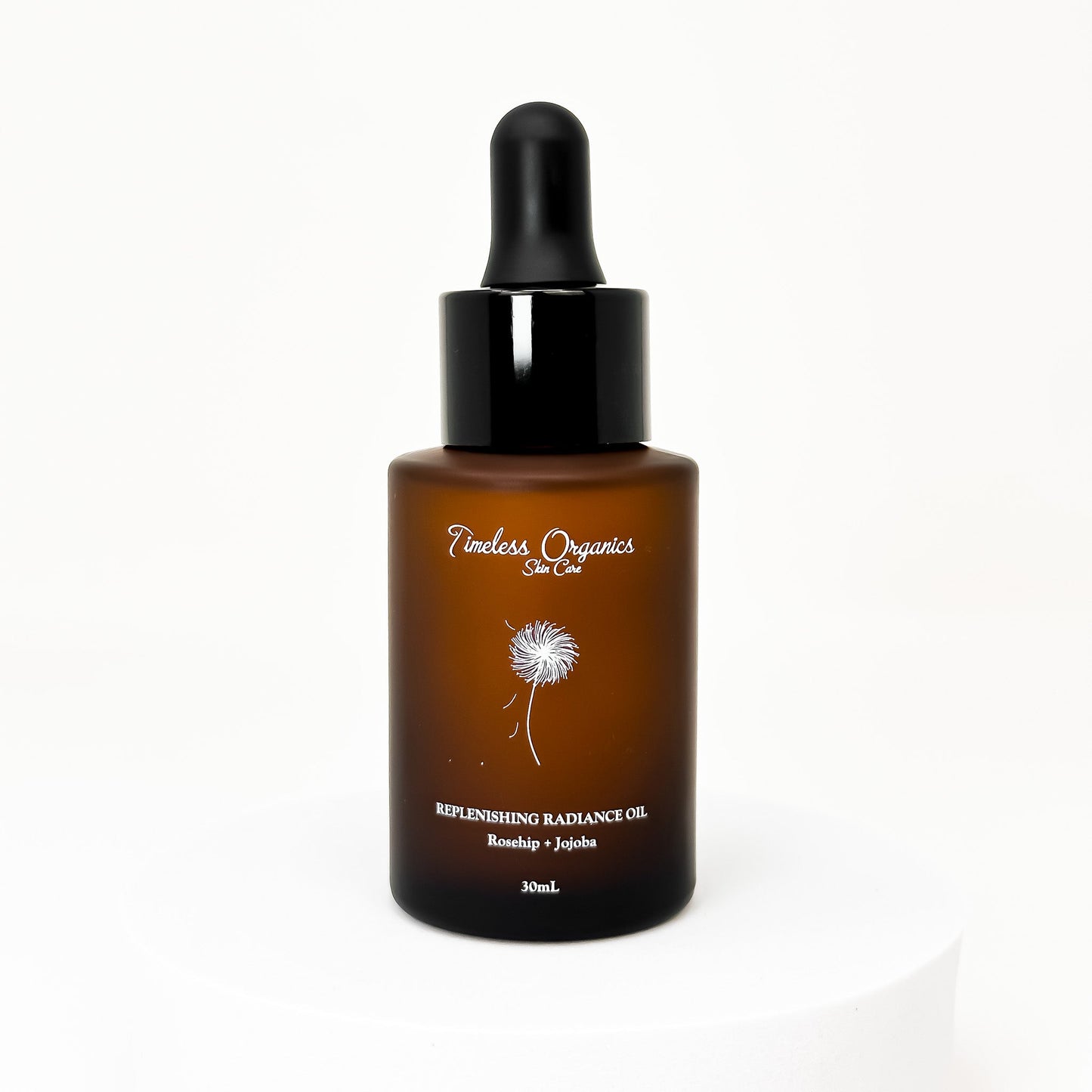 Bottle of Timeless Organics Replenishing Radiance Oil on a white background