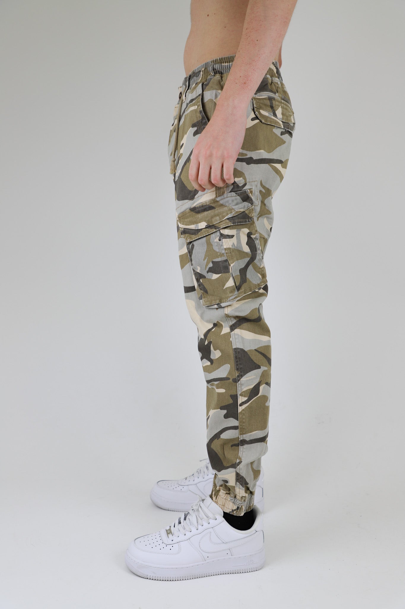 Side view of AR1001 LIGHT CAMO CARGO JOGGERS with elastic cuffs and cargo pockets