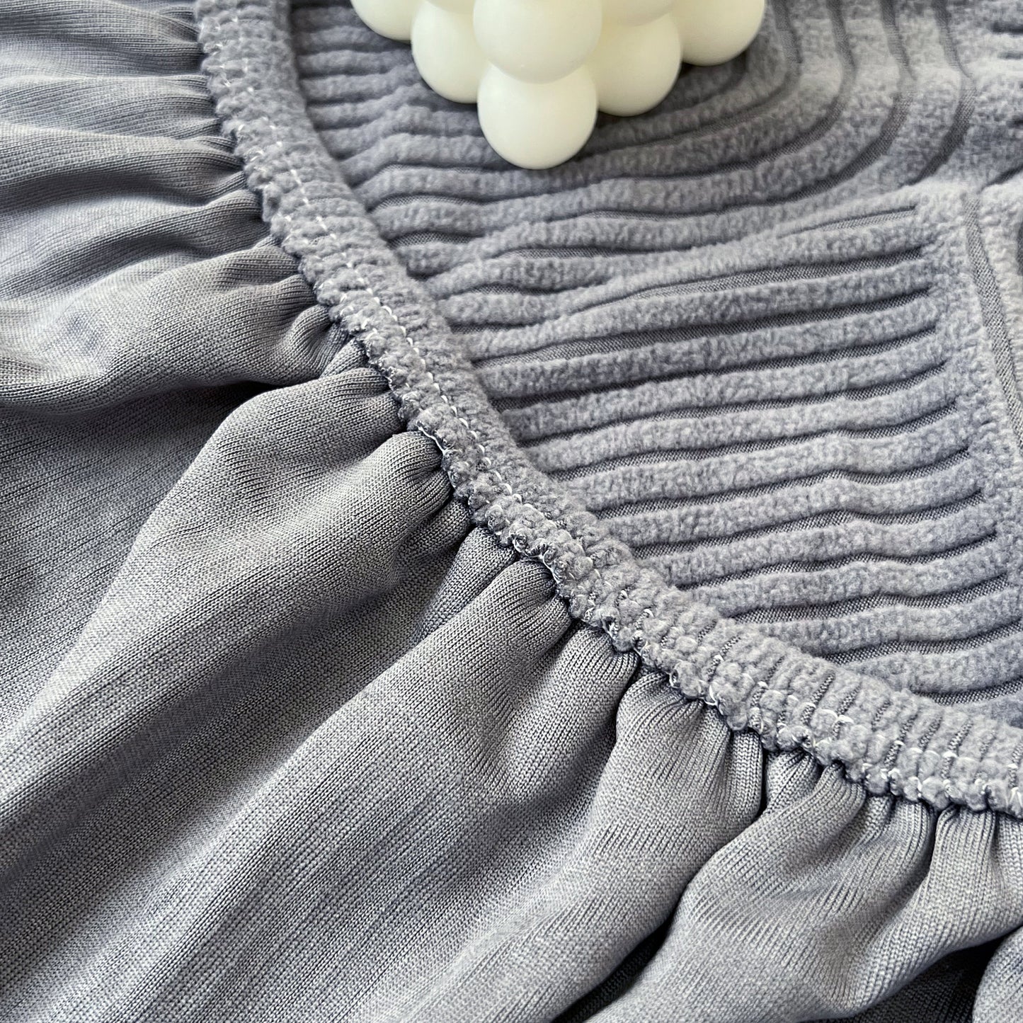 Close-up of gray Stretch Couch Cushion Covers, Washable Chaise Lounge Sofa Slipcover, Elastic Furniture Protector for Pets, Kid