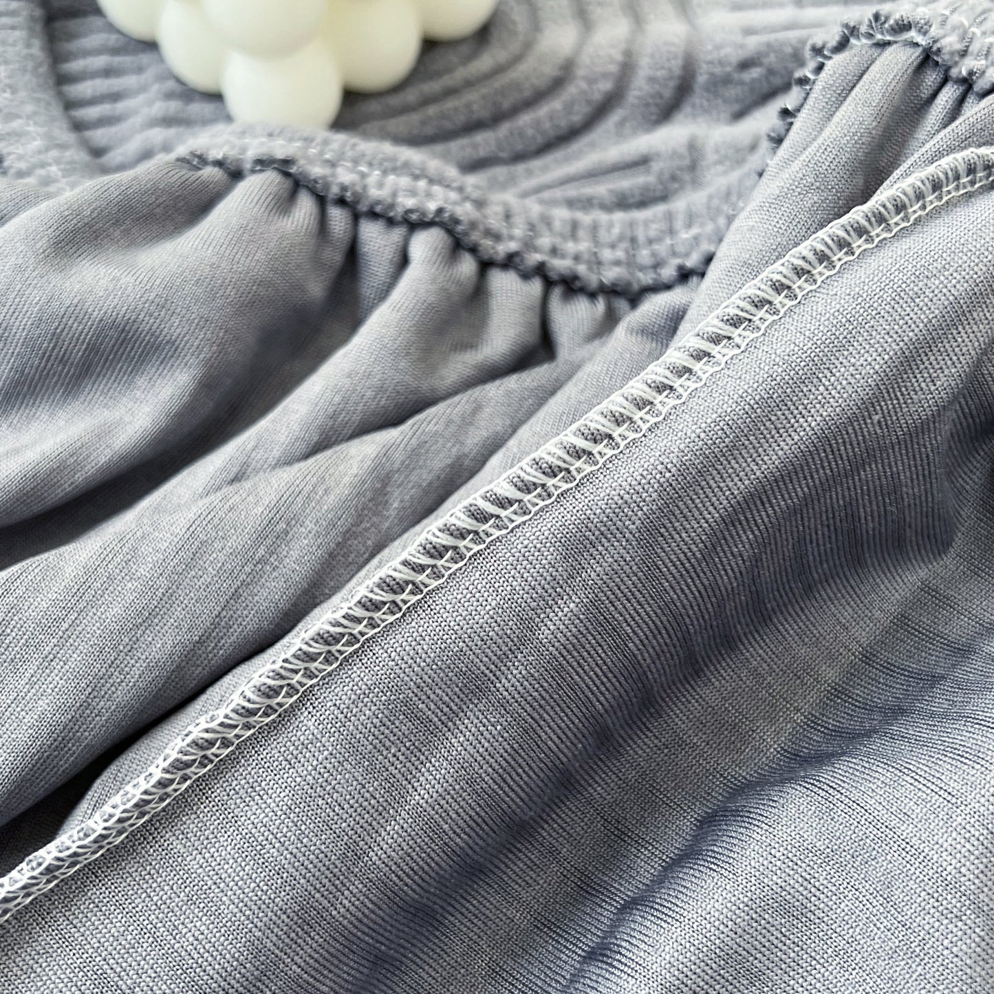 Close-up of Stretch Couch Cushion Covers fabric texture, showing elastic detail, ideal as a Washable Chaise Lounge Sofa Slipcover for pets, kids.