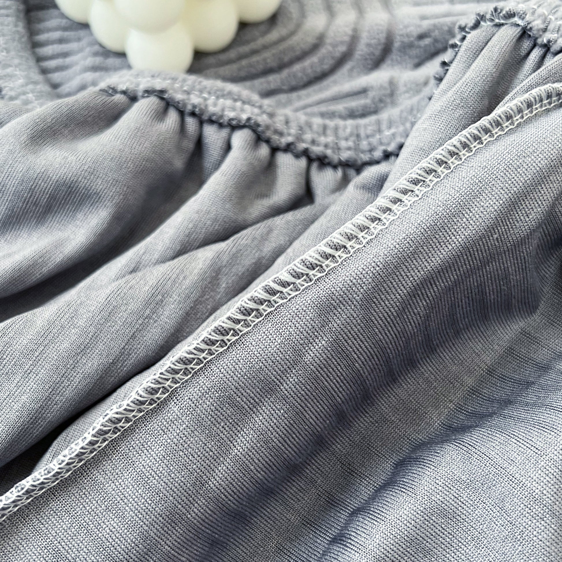 Close-up of Stretch Couch Cushion Covers fabric texture, showing elastic detail, ideal as a Washable Chaise Lounge Sofa Slipcover for pets, kids.