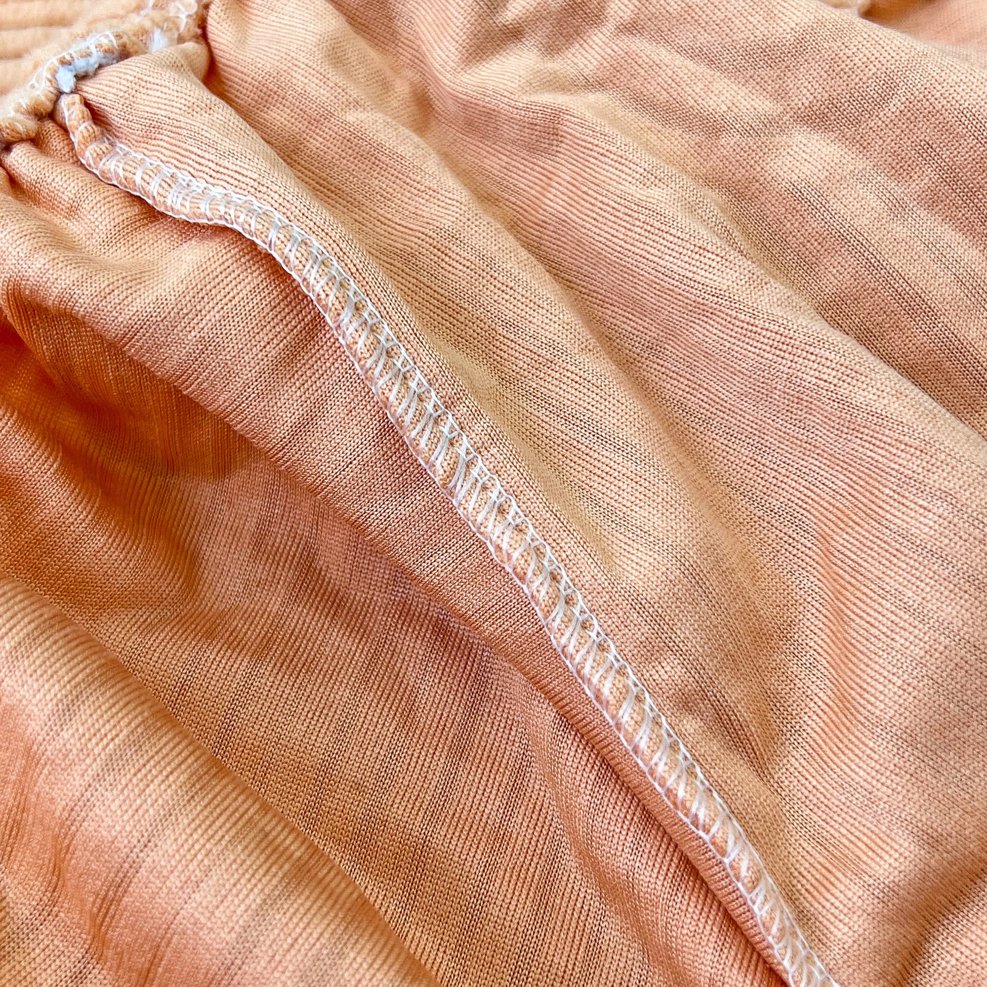 Close-up of Stretch Couch Cushion Covers, Washable Chaise Lounge Sofa Slipcover fabric showing elastic detail for furniture protection.