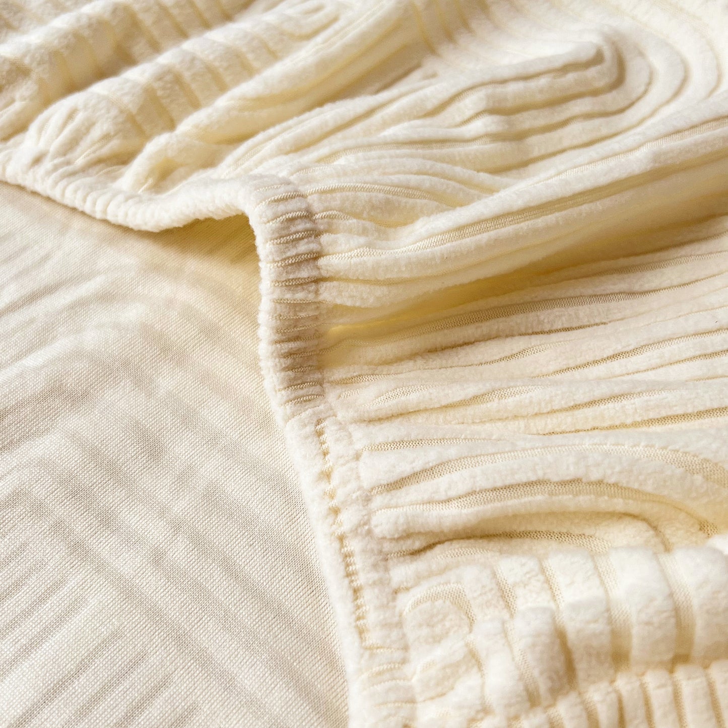Close-up of Stretch Couch Cushion Covers, Washable Chaise Lounge Sofa Slipcover fabric, showing elastic texture and quality material.