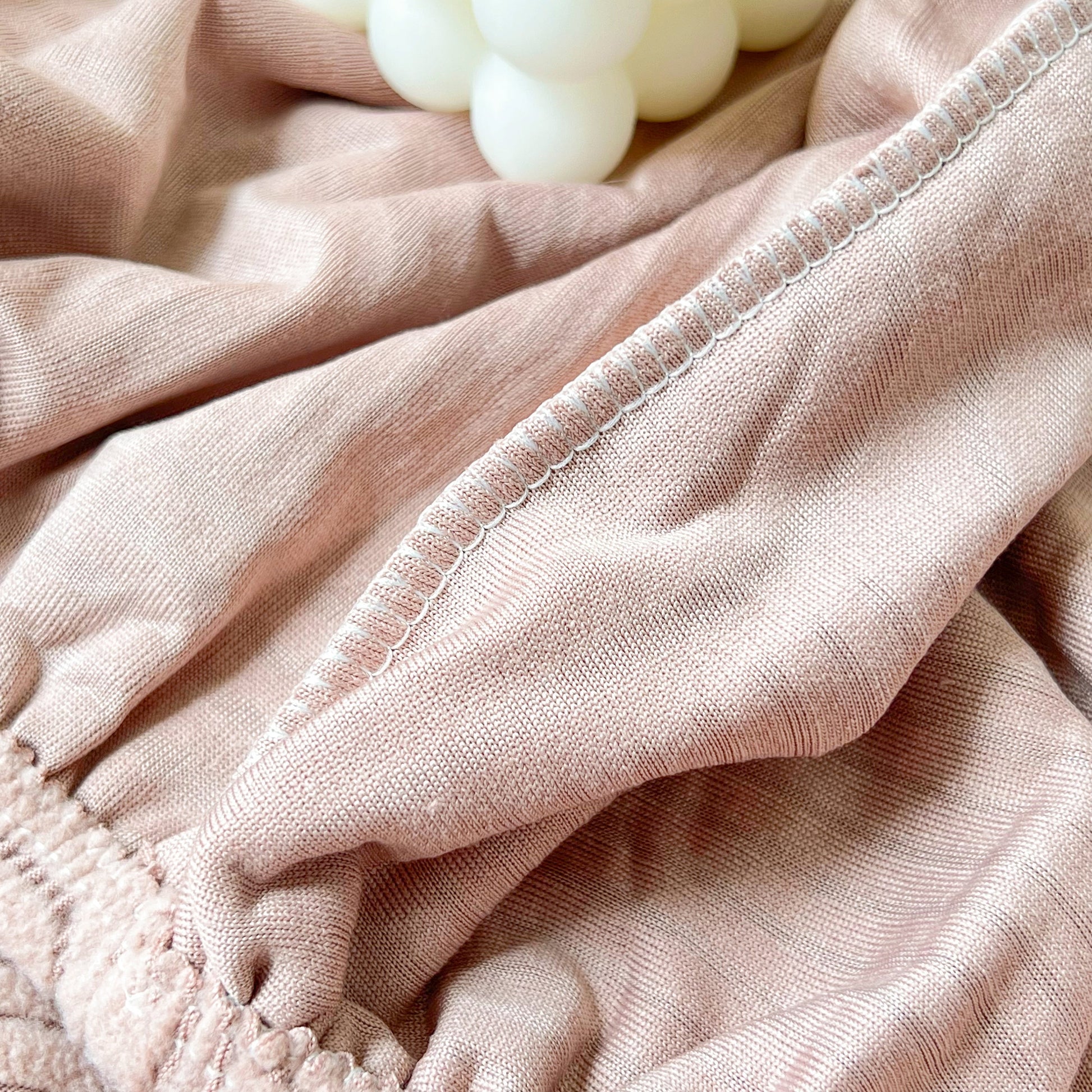 Close-up of pink fabric showcasing the texture of Stretch Couch Cushion Covers, Washable Chaise Lounge Sofa Slipcover, Elastic Furniture Protector.