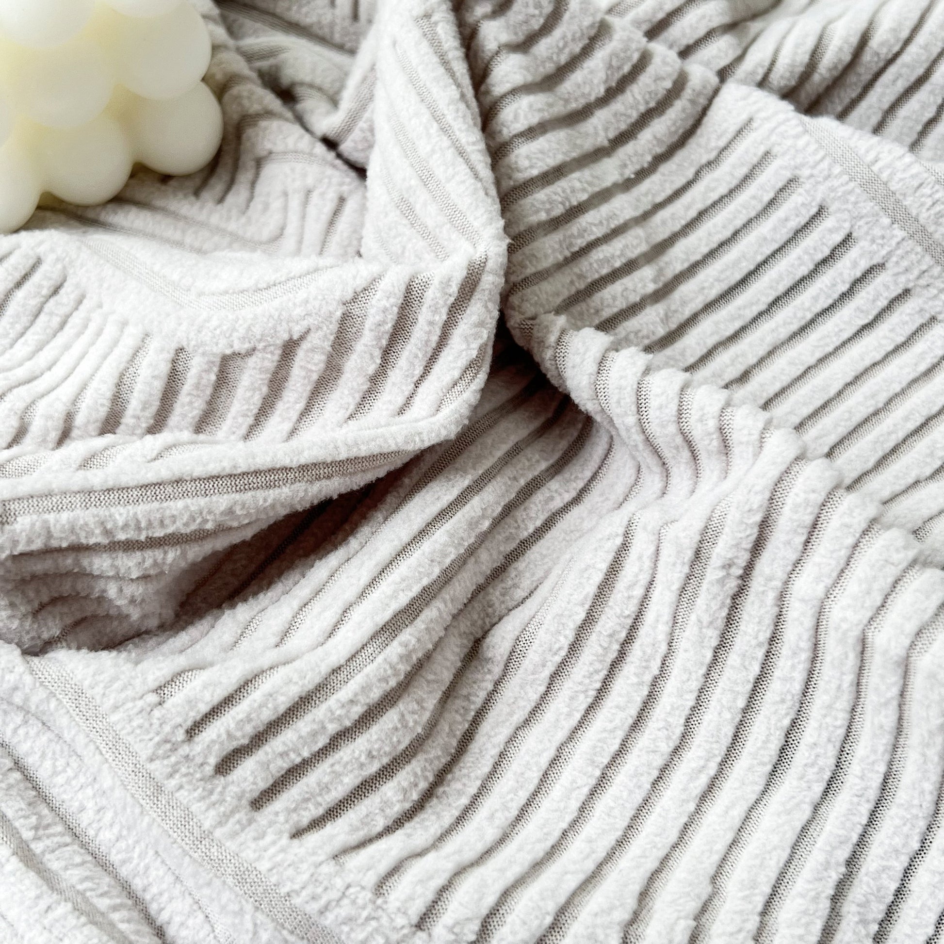 Close-up of Stretch Couch Cushion Covers, Washable Chaise Lounge Sofa Slipcover with textured fabric detail.