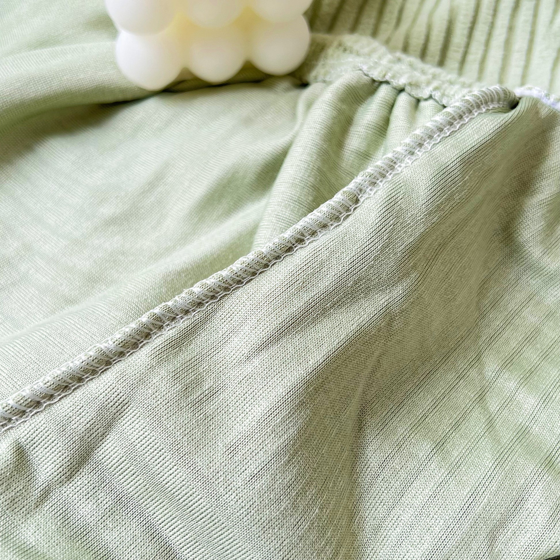 Close-up of Stretch Couch Cushion Covers, Washable Chaise Lounge Sofa Slipcover fabric texture, showing elastic quality.