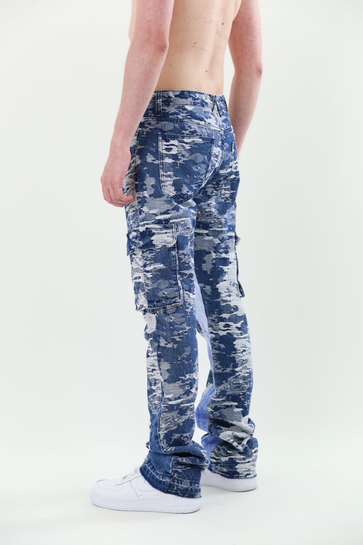 Model wearing AJS695 BLUE CARGO JACQUARD STACKED JEANS showcasing non-stretchy jacquard fabric with five-pocket design and belt loops.