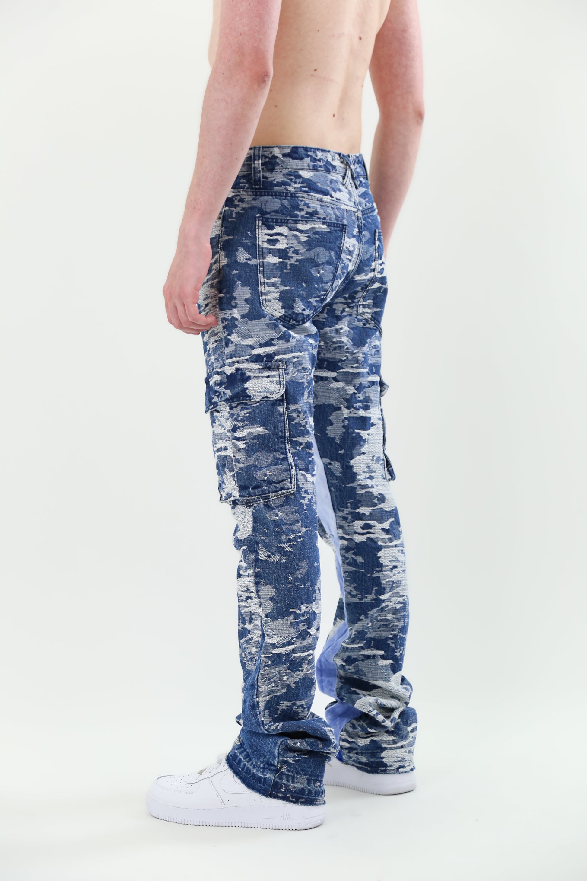 Model wearing AJS695 BLUE CARGO JACQUARD STACKED JEANS showcasing non-stretchy jacquard fabric with five-pocket design and belt loops.