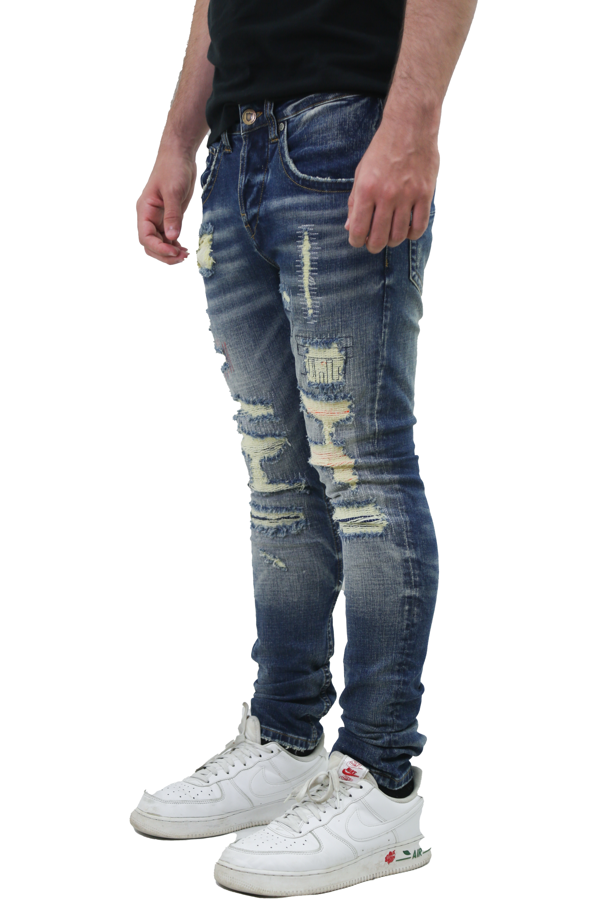Person wearing RIPPED MID-RISE SKINNY JEANS with a mid-rise design, five-pocket style, and button fly, made of stretchy cotton fabric.