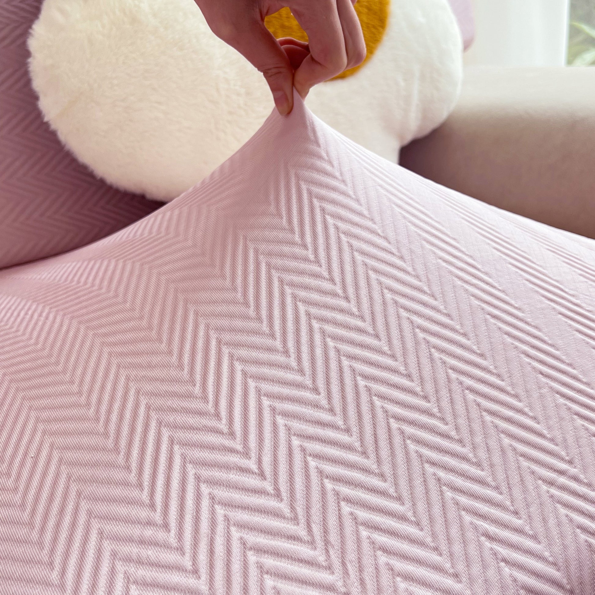 Hand stretching pink Cooling Stretchy Replacement Couch Cushion Covers for Sectional, Individual Couch Seat Cushion Covers