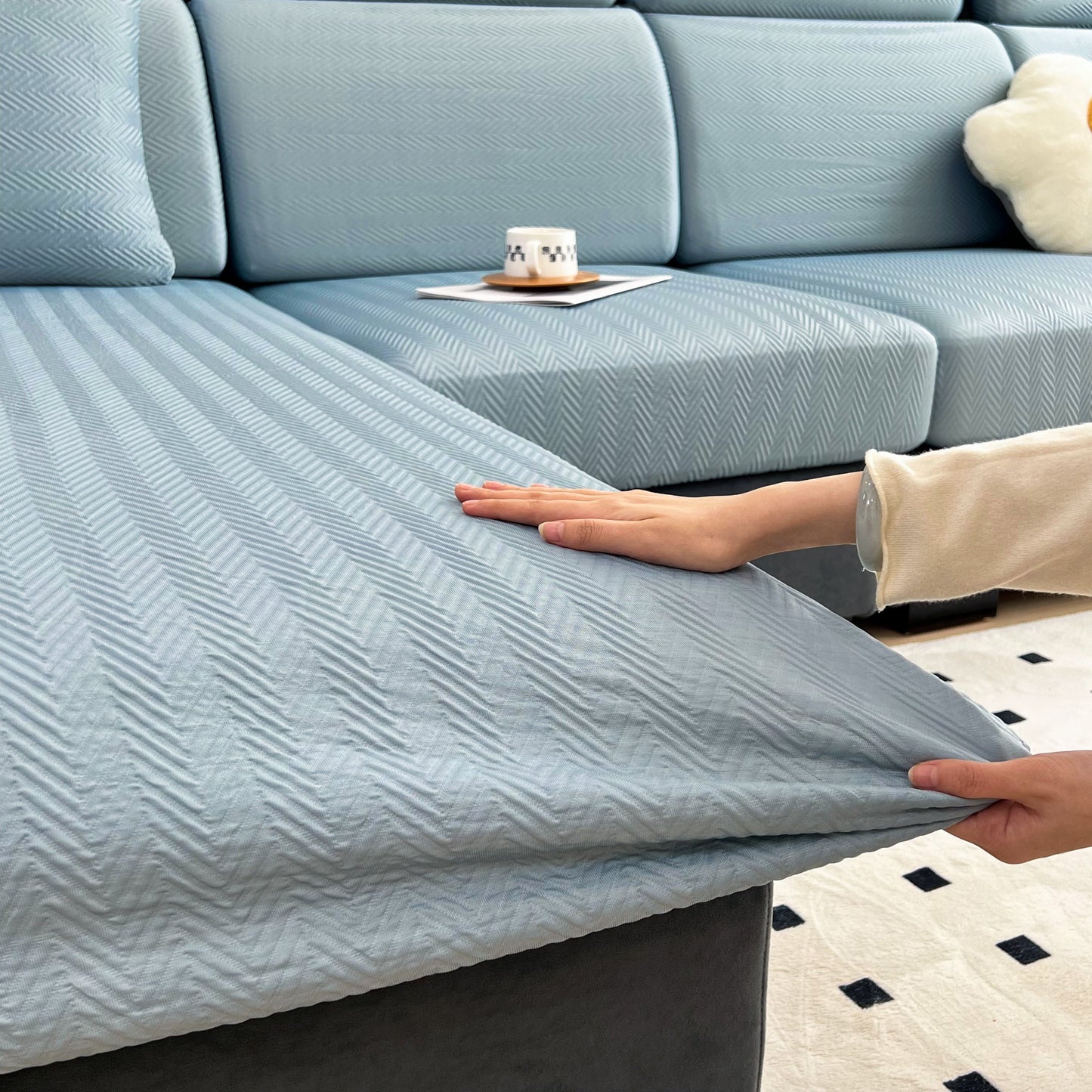 Hand adjusting Cooling Stretchy Replacement Couch Cushion Covers for Sectional, Individual Couch Seat Cushion Covers on sofa.