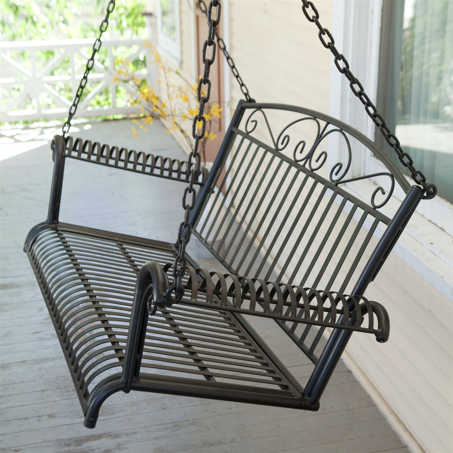 Wrought Iron Outdoor Patio 4-Ft Porch Swing in Black with scrolled arms and slatted backrest, perfect for outdoor relaxation.