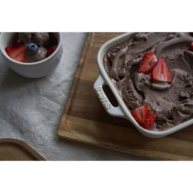 2 Piece Ceramic Stoneware Baking Dish Set in Ivory Cream Beige with dessert topped with strawberries on wooden board