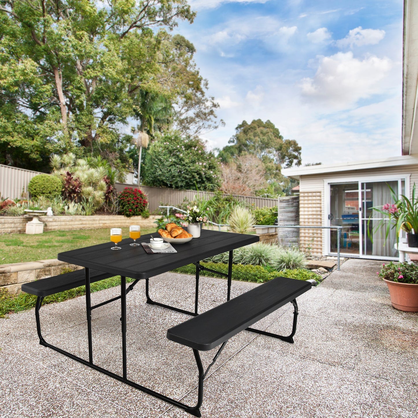 Indoor and Outdoor Folding Picnic Table Bench Set with Wood-like Texture-Black in a garden setting