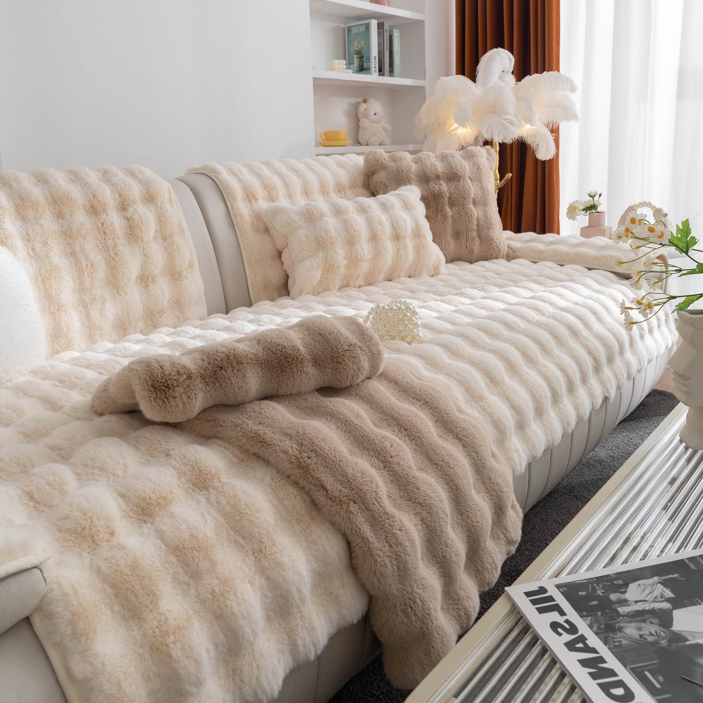 Living room with thick sofa cushion solid color faux fur fluffy sofa cushion non-slip couch covers in beige on a cream sofa.