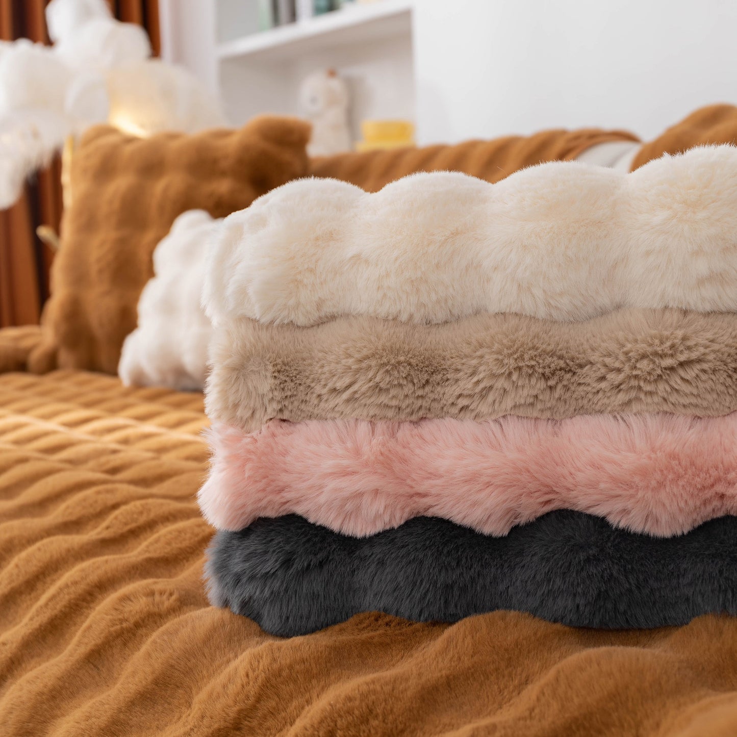 Stack of Thick Sofa Cushion Solid Color Faux Fur Fluffy Sofa Cushion Non-Slip Couch Covers in various colors on a bed