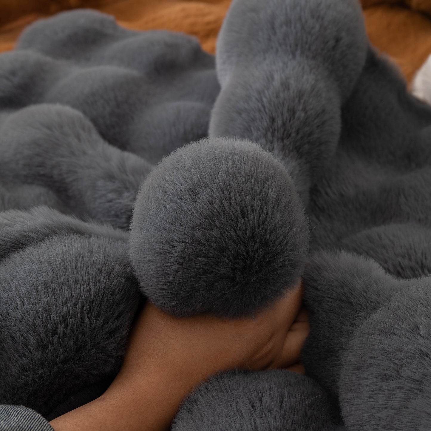 Thick Sofa Cushion Solid Color Faux Fur Fluffy Sofa Cushion Non-Slip Couch Covers with hand touching soft plush surface.