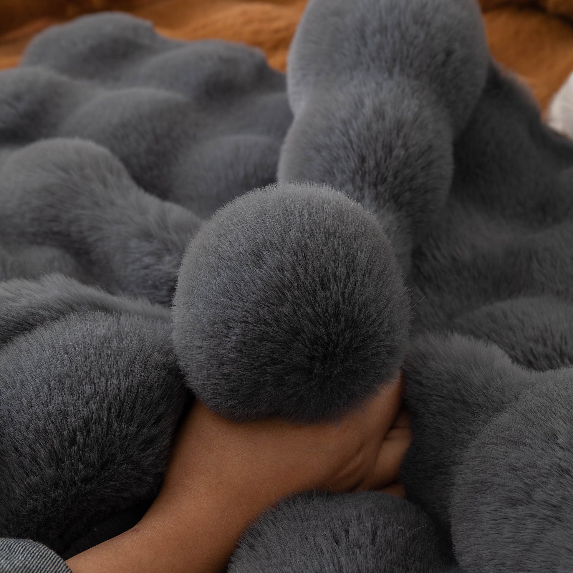 Thick Sofa Cushion Solid Color Faux Fur Fluffy Sofa Cushion Non-Slip Couch Covers with hand touching soft plush surface.