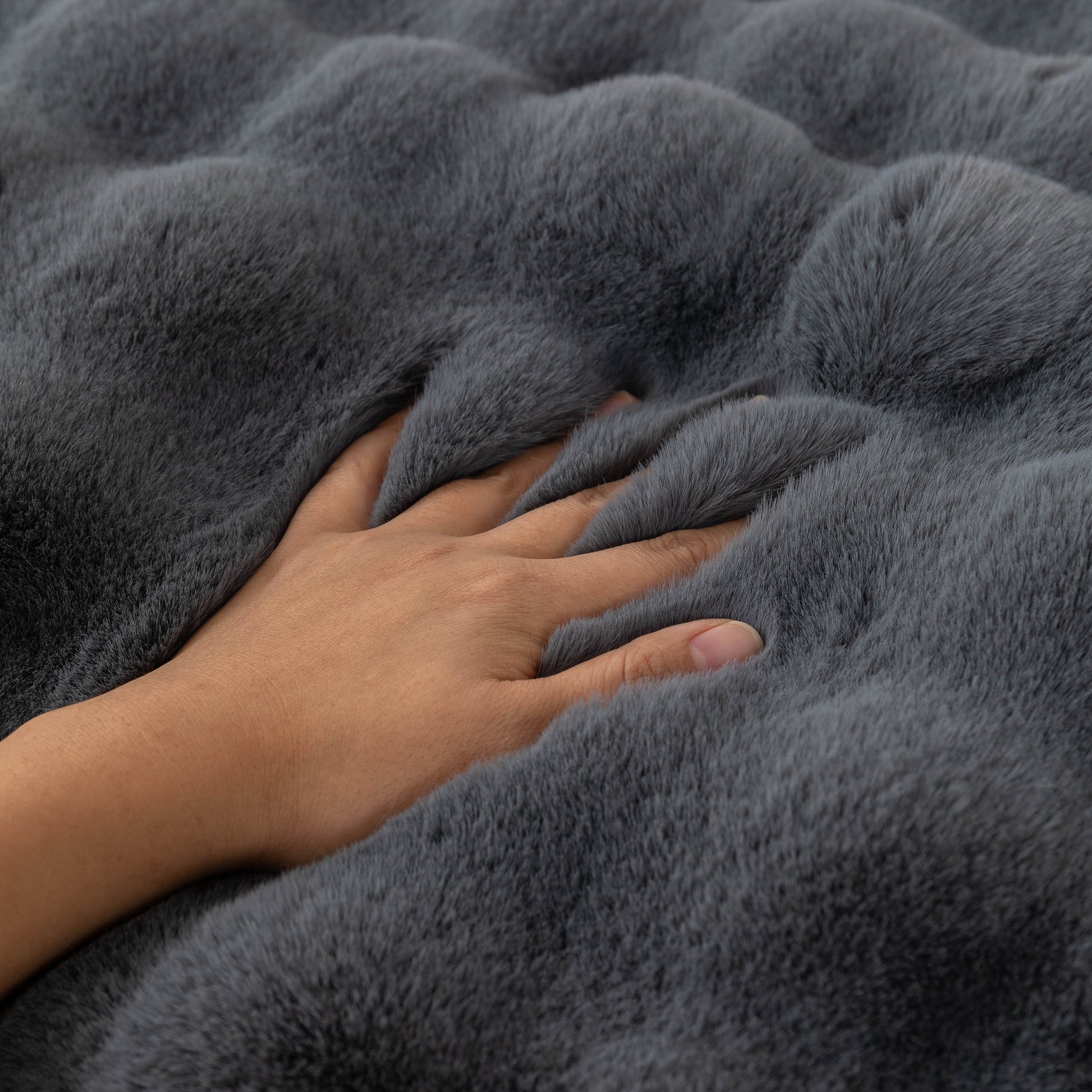 Hand touching Thick Sofa Cushion Solid Color Faux Fur Fluffy Sofa Cushion Non-Slip Couch Covers showcasing its plush texture.