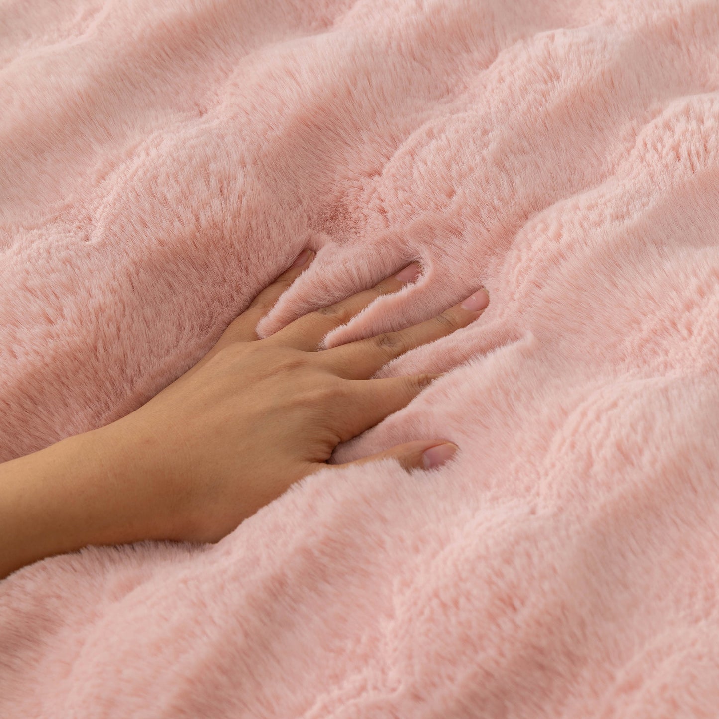 Hand touching Thick Sofa Cushion Solid Color Faux Fur Fluffy Sofa Cushion Non-Slip Couch Covers in pink, highlighting plush comfort.