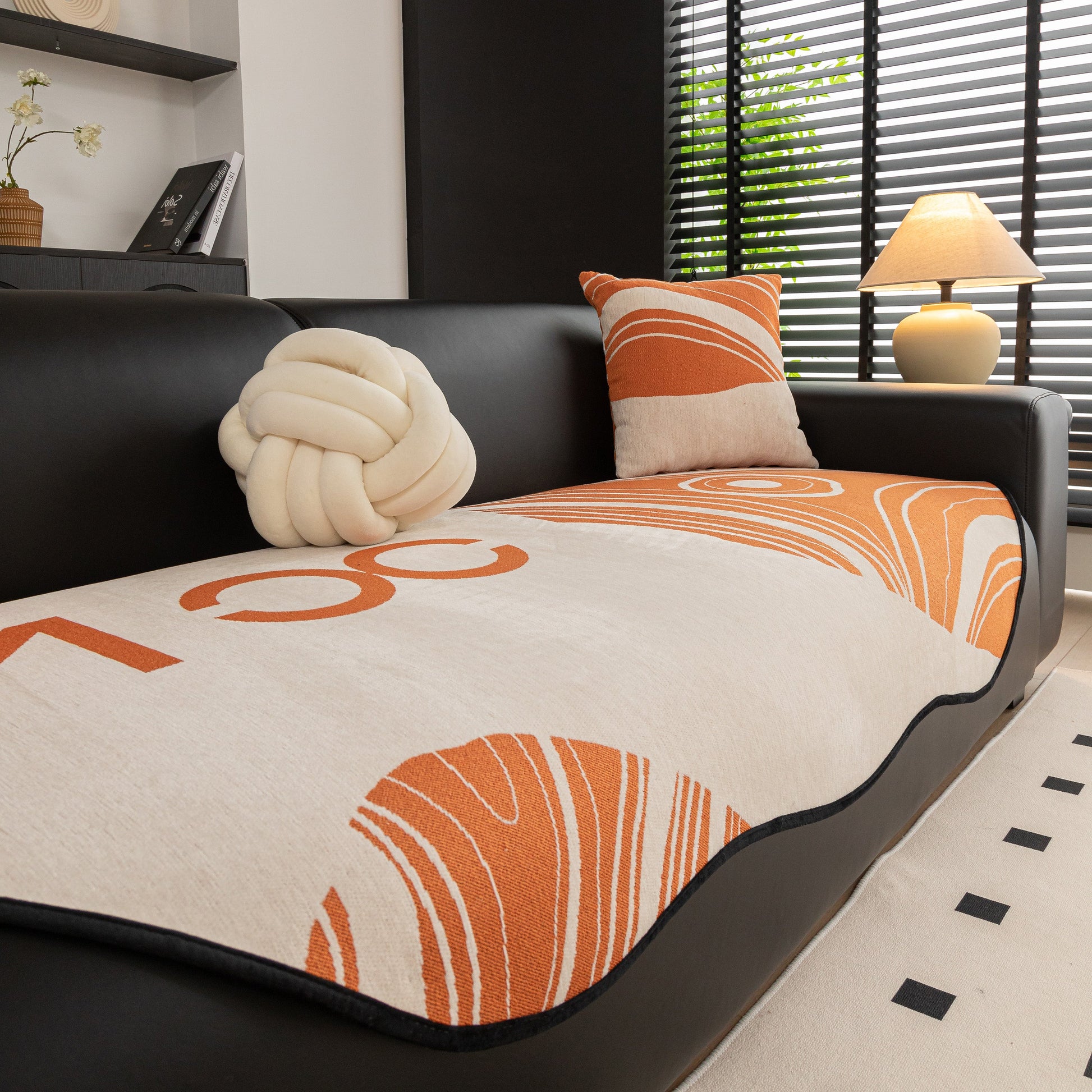 Abstract Art Sofa Cover with Wave Edge, Non Slip Couch Cover for Stylish Homes with bold patterns on a black sofa.