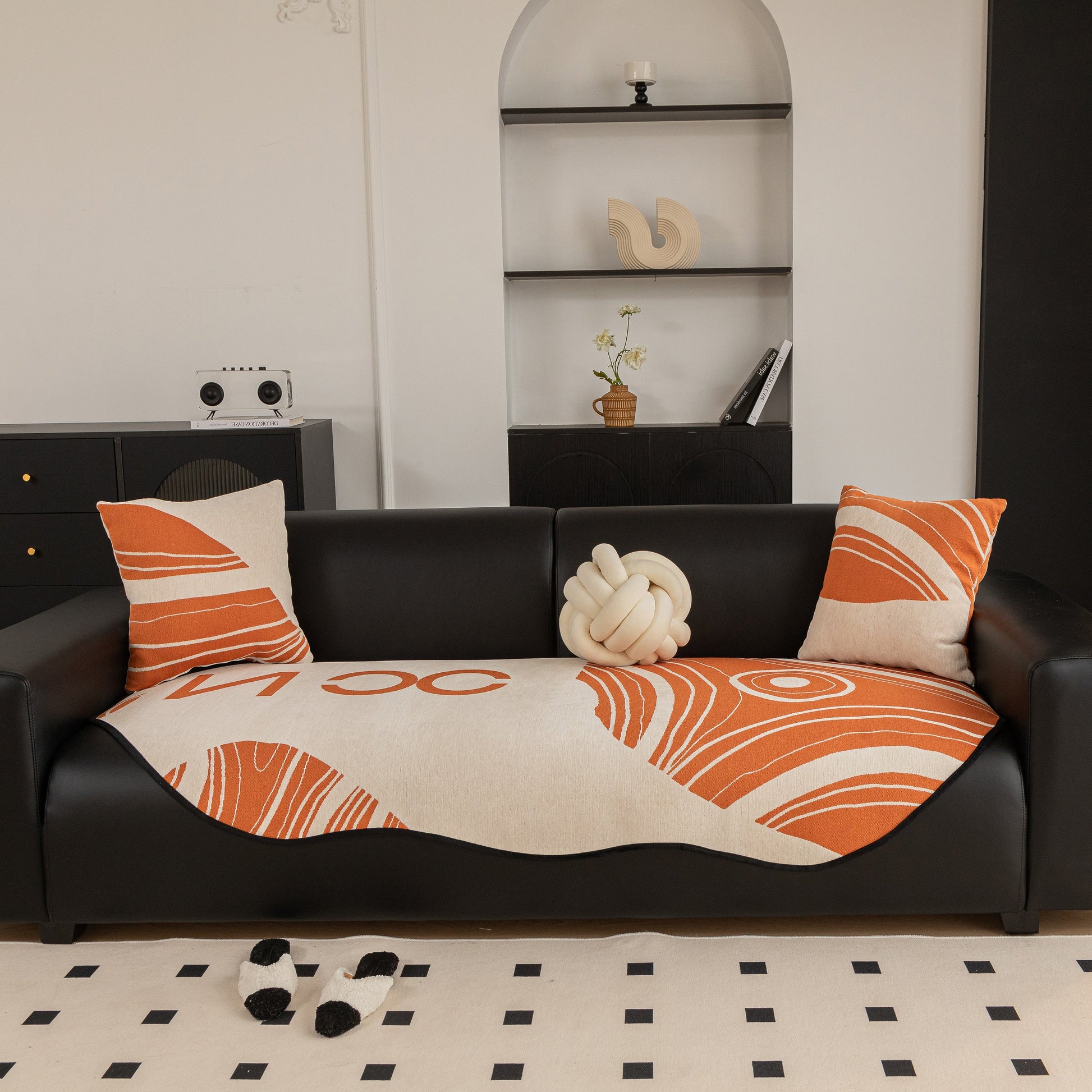 Abstract Art Sofa Cover with Wave Edge, Non Slip Couch Cover for Stylish Homes, featuring bold line-based pattern on black sofa