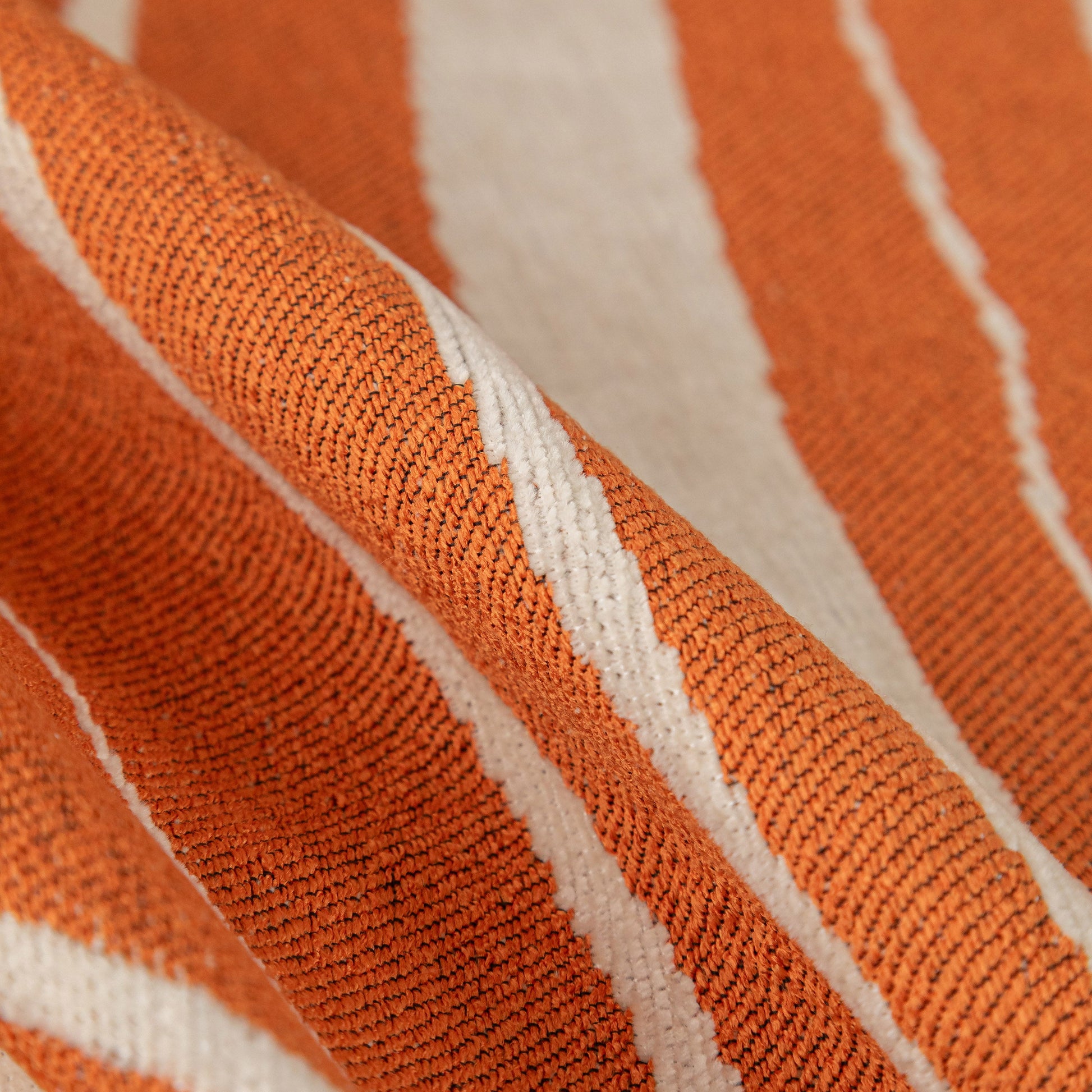 Close-up of Abstract Art Sofa Cover with Wave Edge, Non Slip Couch Cover for Stylish Homes in orange chenille fabric.
