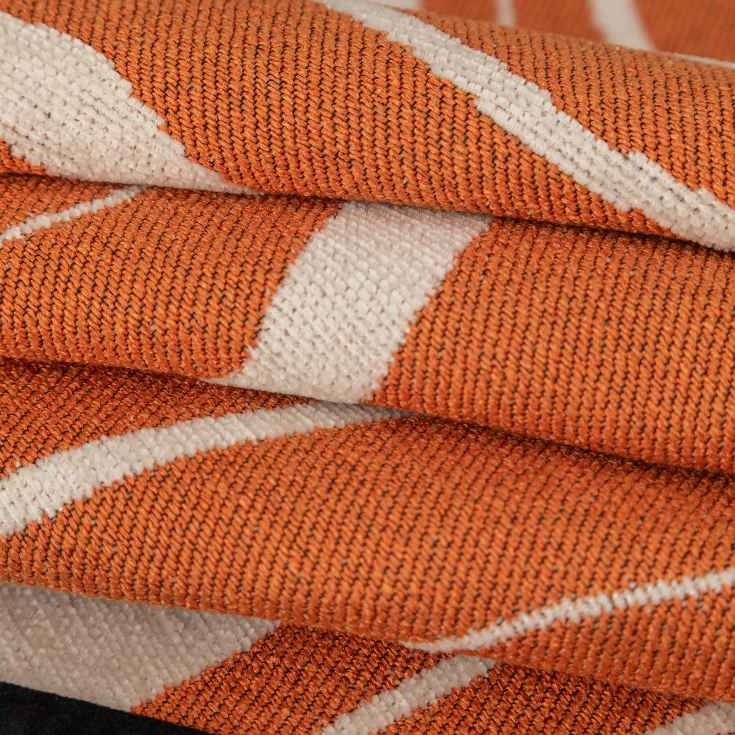 Close-up of Abstract Art Sofa Cover with Wave Edge, Non Slip Couch Cover for Stylish Homes in vibrant orange and white chenille fabric.