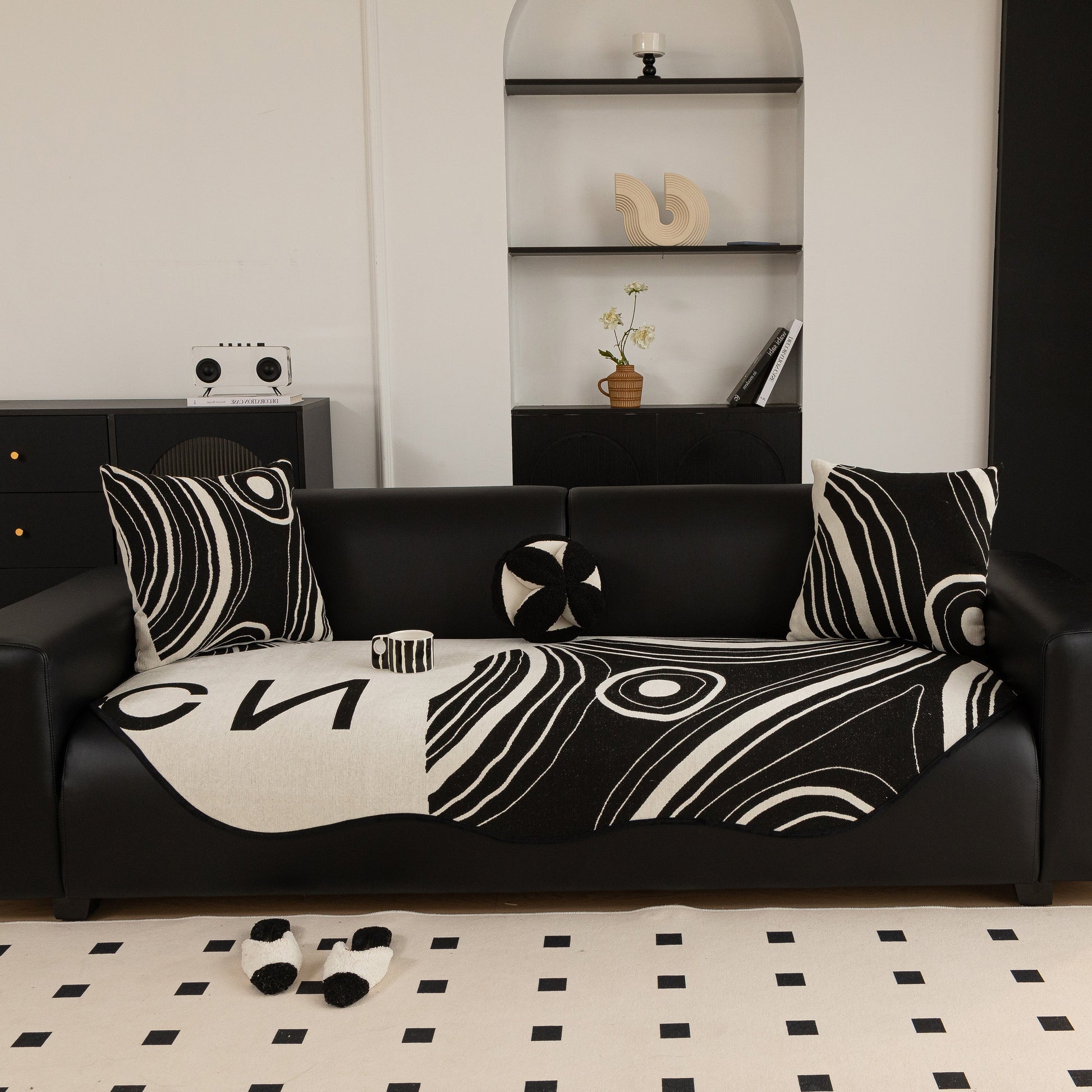 Abstract Art Sofa Cover with Wave Edge, Non Slip Couch Cover for Stylish Homes in black and white abstract pattern on a living room sofa.