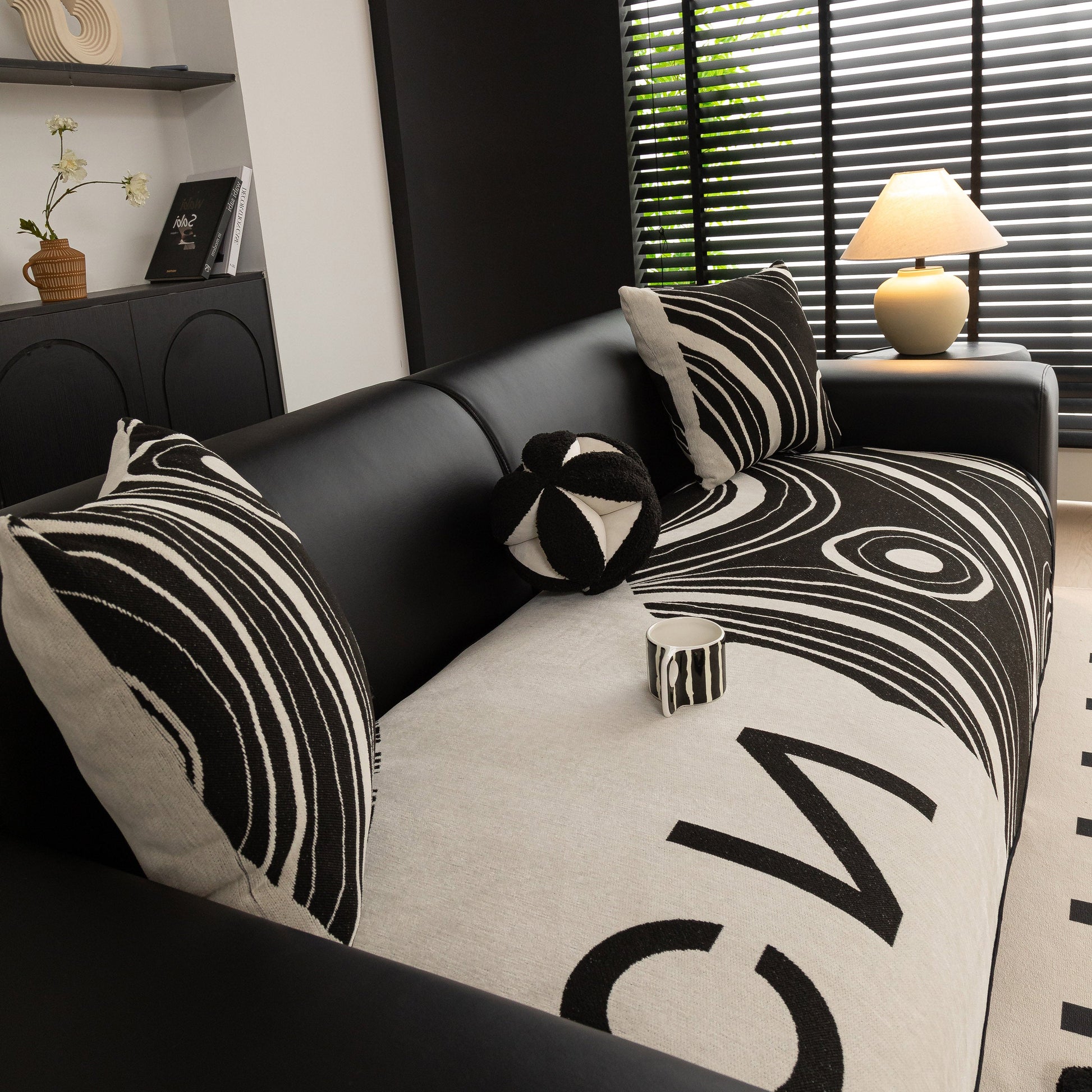Abstract Art Sofa Cover with Wave Edge, Non Slip Couch Cover for Stylish Homes in black and white design on a modern sofa