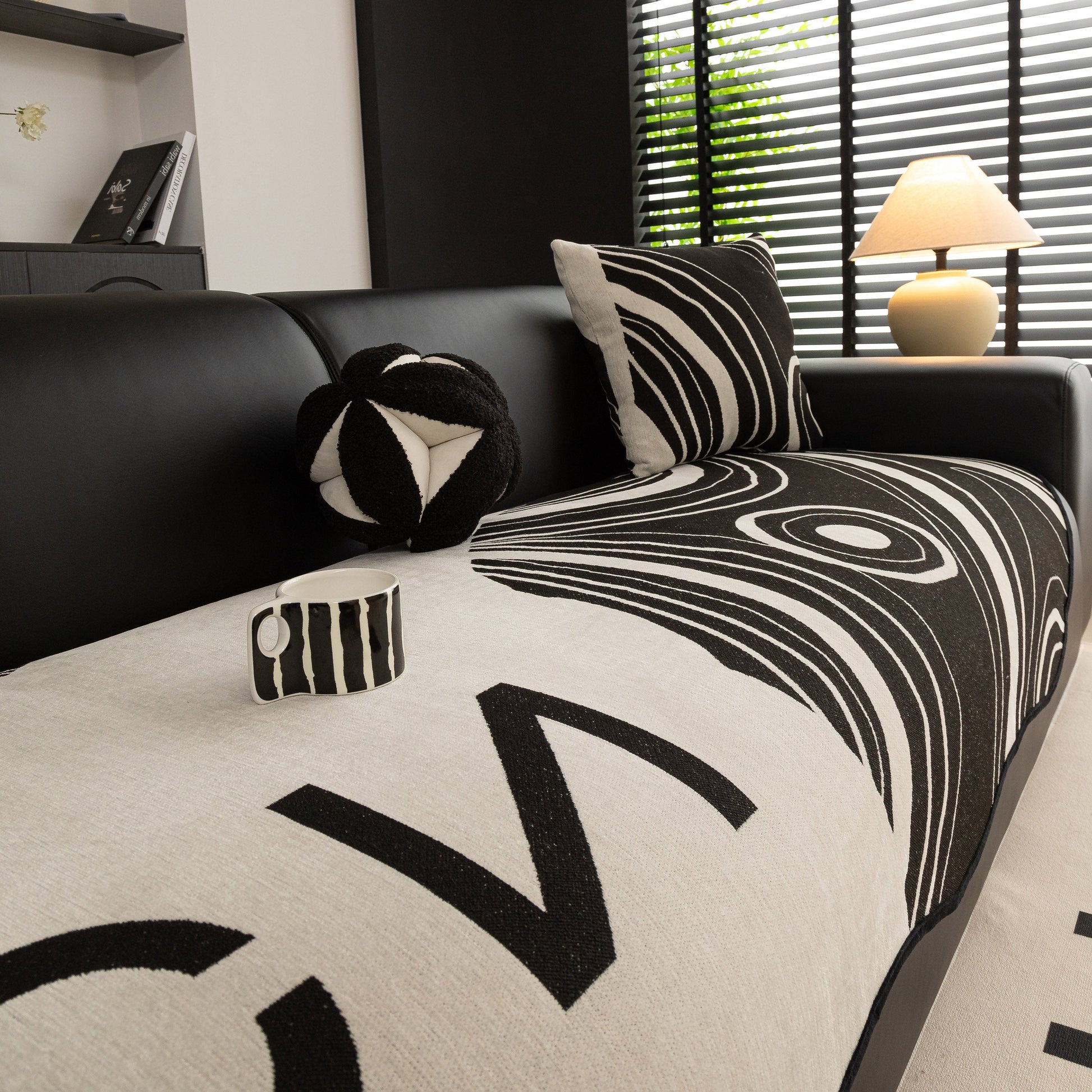 Abstract Art Sofa Cover with Wave Edge, Non Slip Couch Cover for Stylish Homes displayed on black sofa with zebra pattern