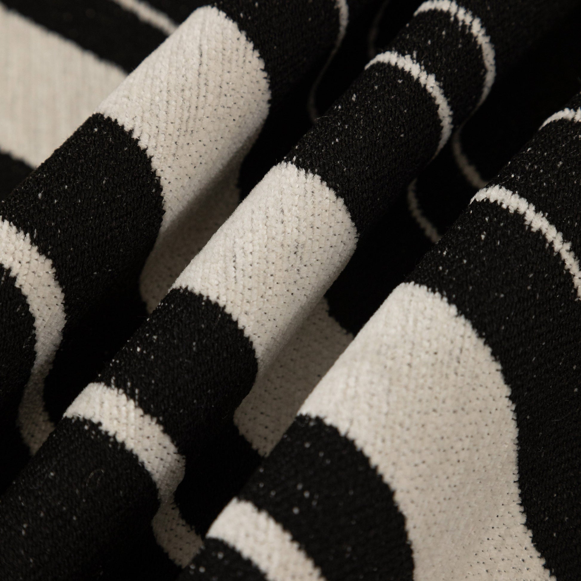 Close-up of Abstract Art Sofa Cover with Wave Edge, Non Slip Couch Cover for Stylish Homes, black and white abstract pattern.