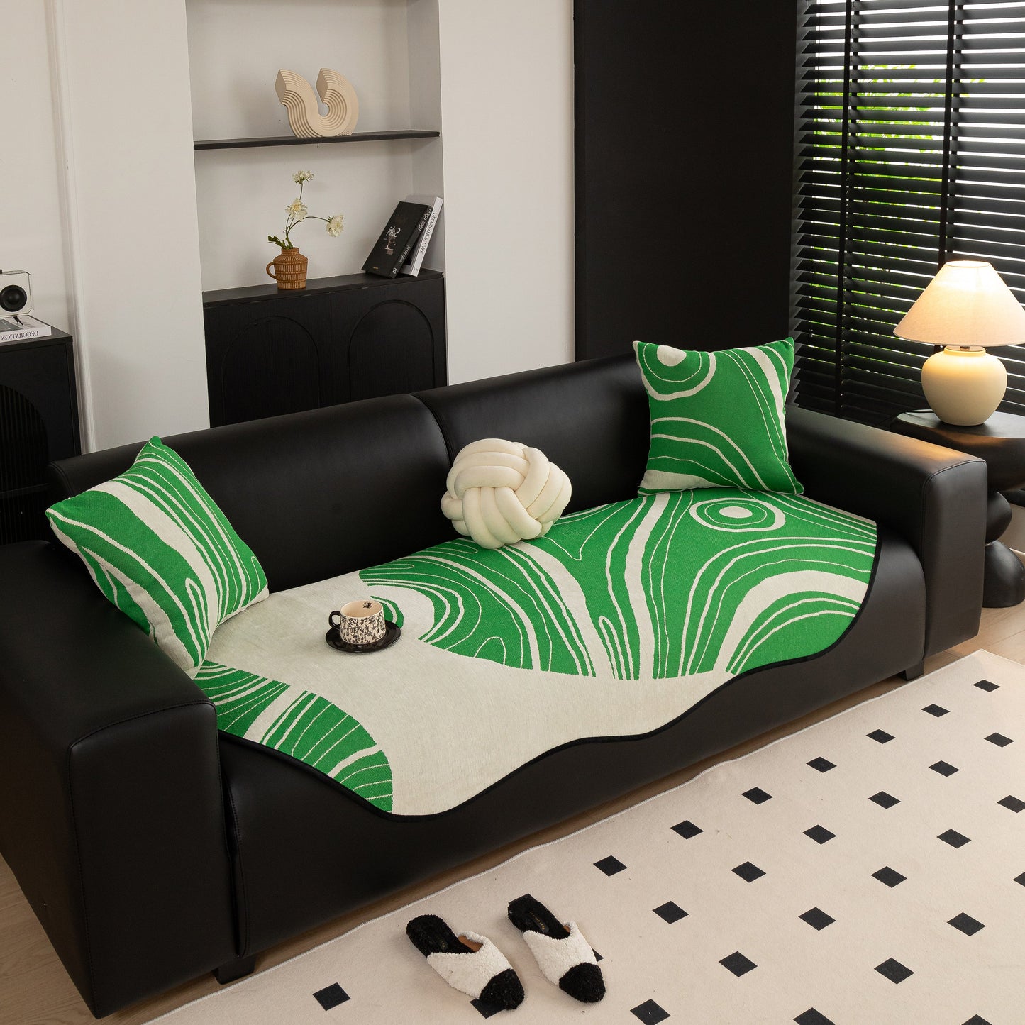 Abstract Art Sofa Cover with Wave Edge, Non Slip Couch Cover for Stylish Homes in green and white abstract pattern on a black sofa.