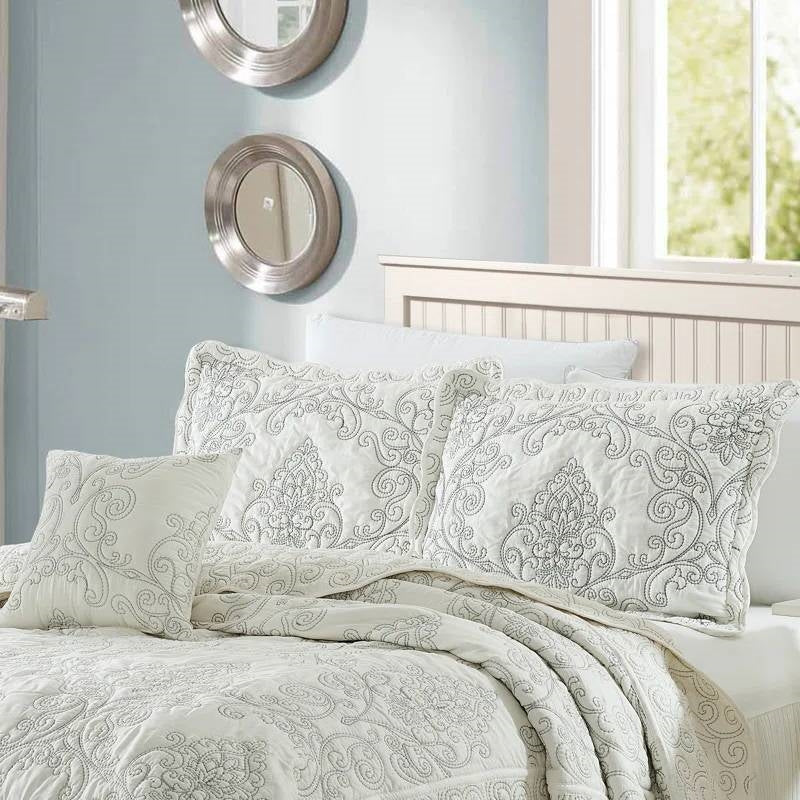 King size Antique White Damask Embroidered 4 Piece Oversized Bedspread Set displayed on a neatly made bed in a bright room.