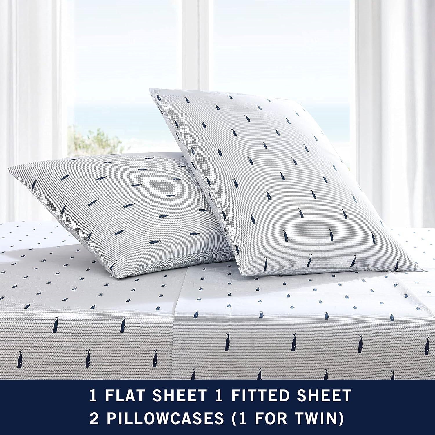 King size Coastal Beach 100-Percent Cotton Navy Blue White Stripe Sheet Set on bed with ocean view.