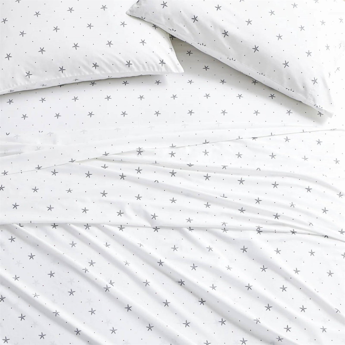 King size Coastal Beach Starfish White Navy Red 100-Percent Cotton Sheet Set on a bed