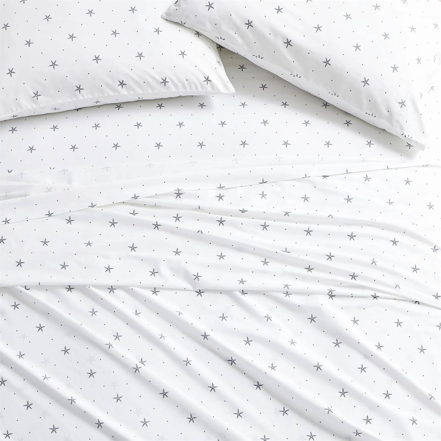 King size Coastal Beach Starfish White Navy Red 100-Percent Cotton Sheet Set on a bed