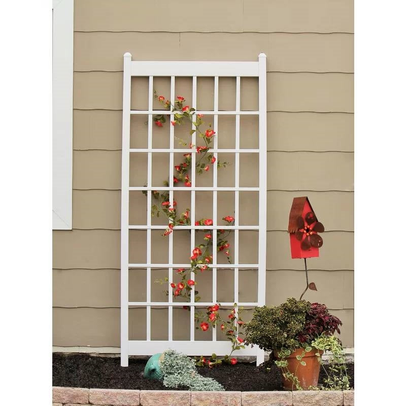 Outdoor 85-inch x 38-inch White PVC Vinyl Lattice Garden Trellis with climbing plants against a wall.