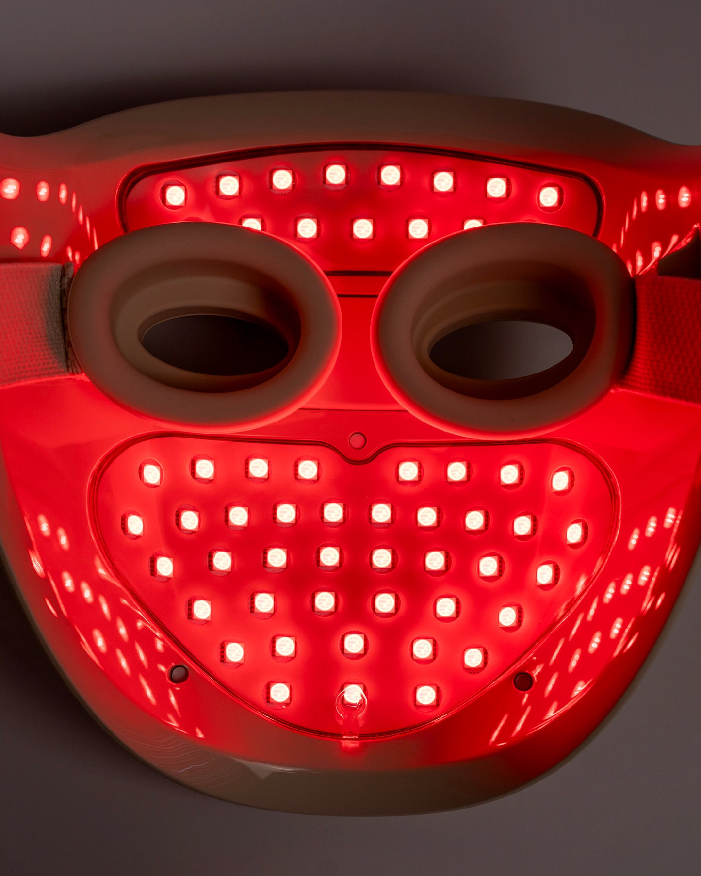 Red-lit Helio Professional-Grade LED Photon Therapy Mask by Blyss for advanced skincare treatment at home.