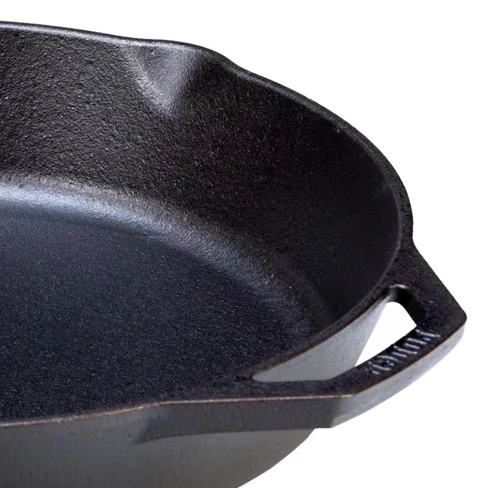 Close-up of the 12-inch Cast Iron Skillet Frying Pan with Pour Spout - Made in the USA, showing seasoned surface and handle.