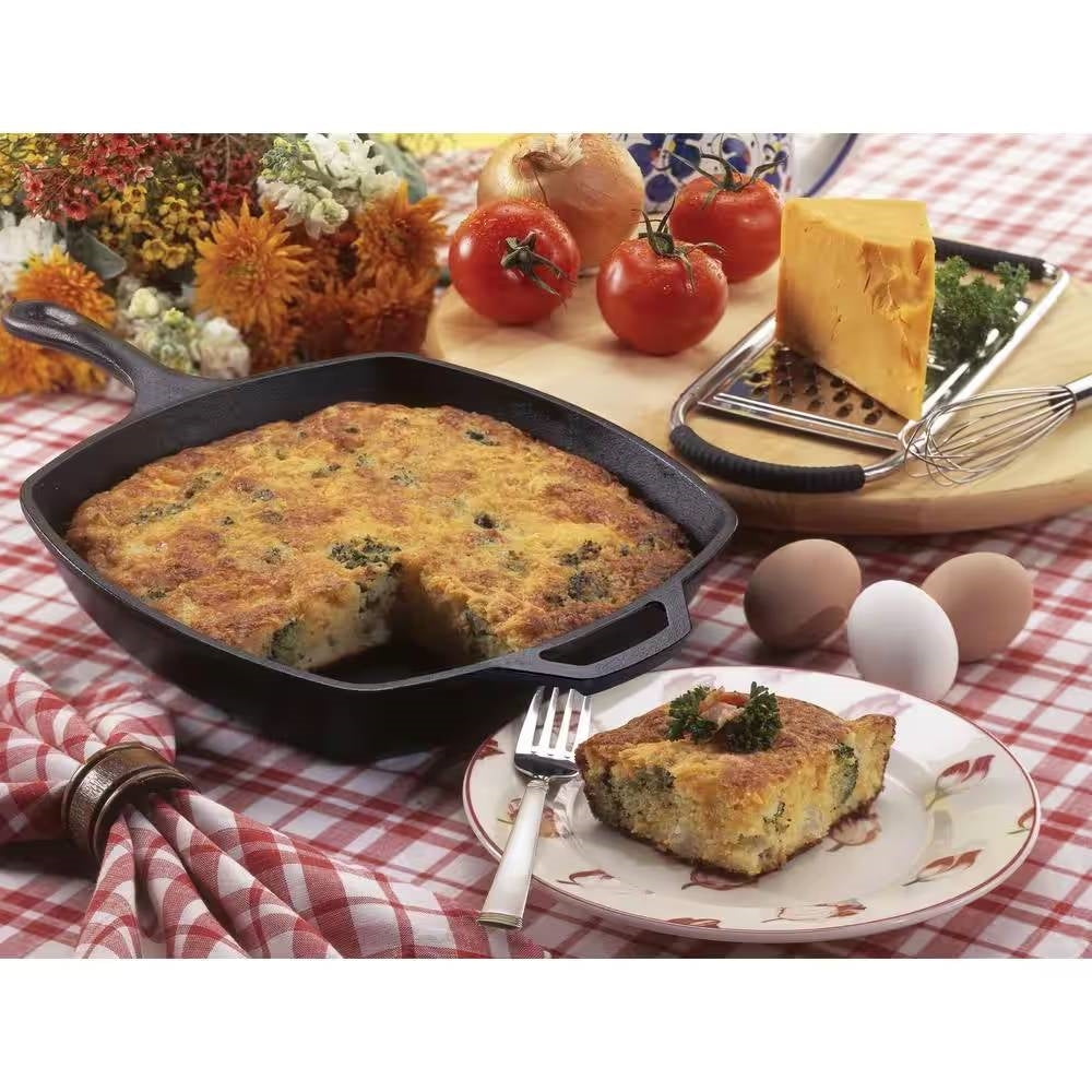 10.5-inch Square Cast Iron Skillet Frying Pan - Made in USA with baked dish, vegetables, cheese, and eggs on a table.