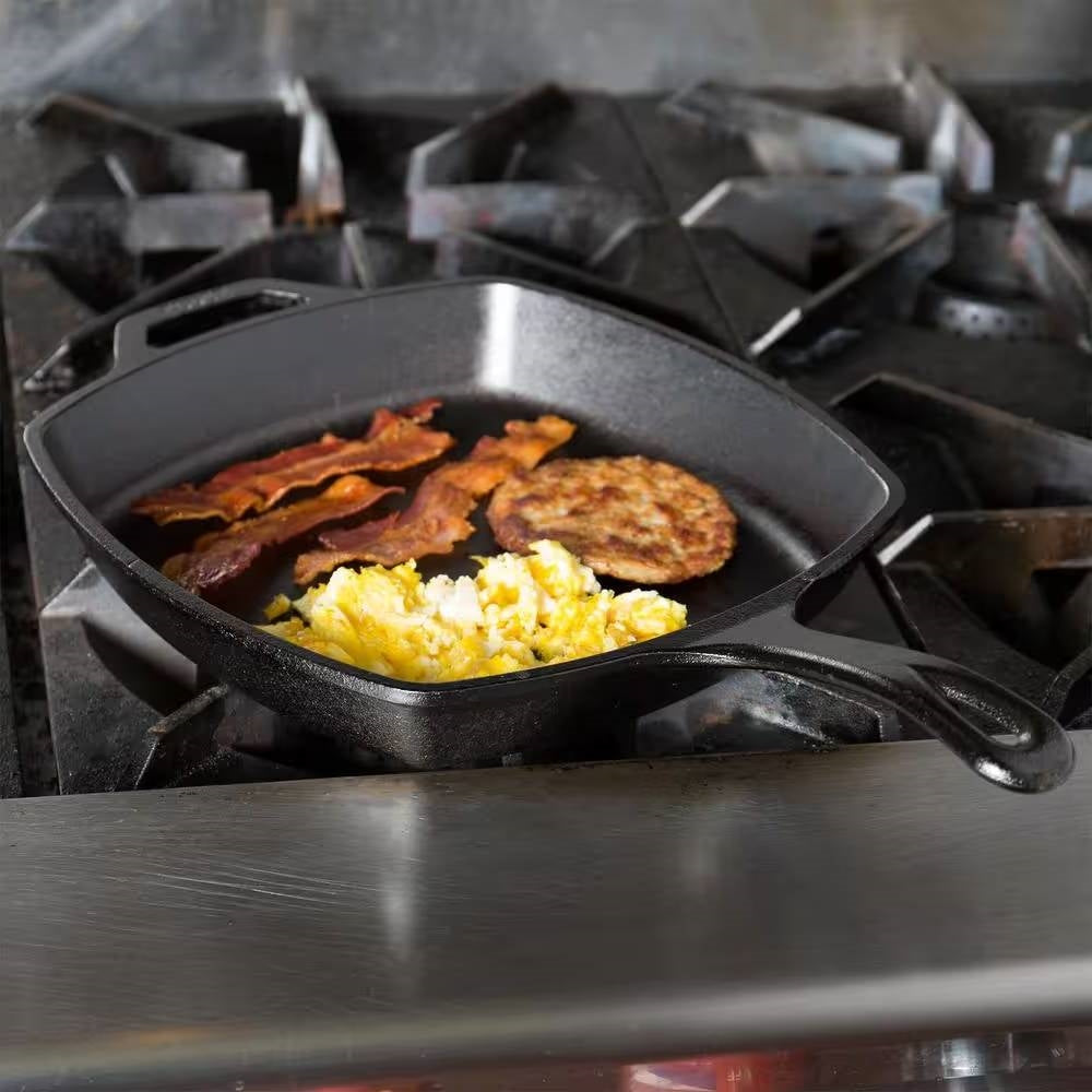 10.5-inch Square Cast Iron Skillet Frying Pan - Made in USA on stove with bacon, scrambled eggs, and a patty.